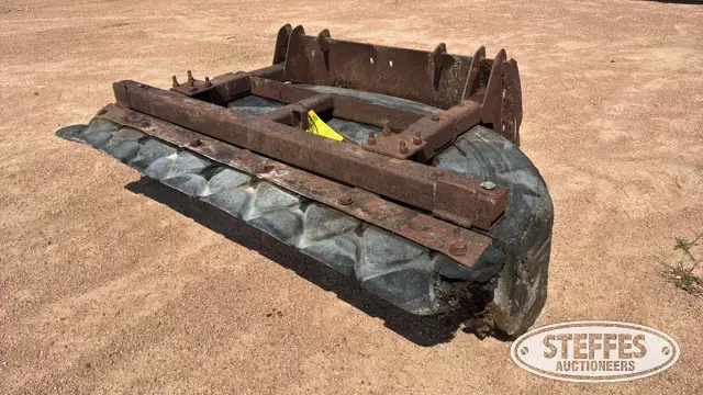 Skid steer tire scraper