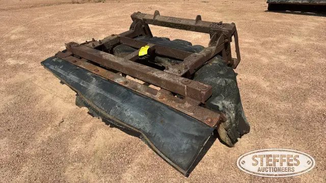 Skid steer tire scraper