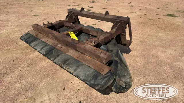 Skid steer tire scraper